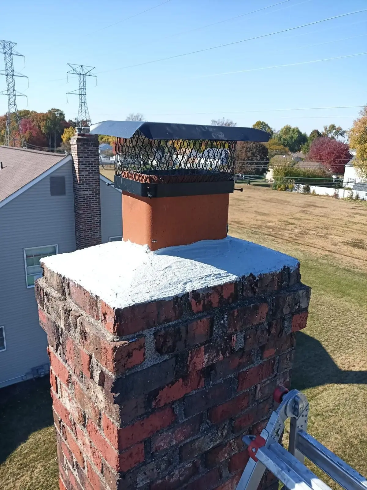 Brick chimney with a new cap on an Arlington-area home
