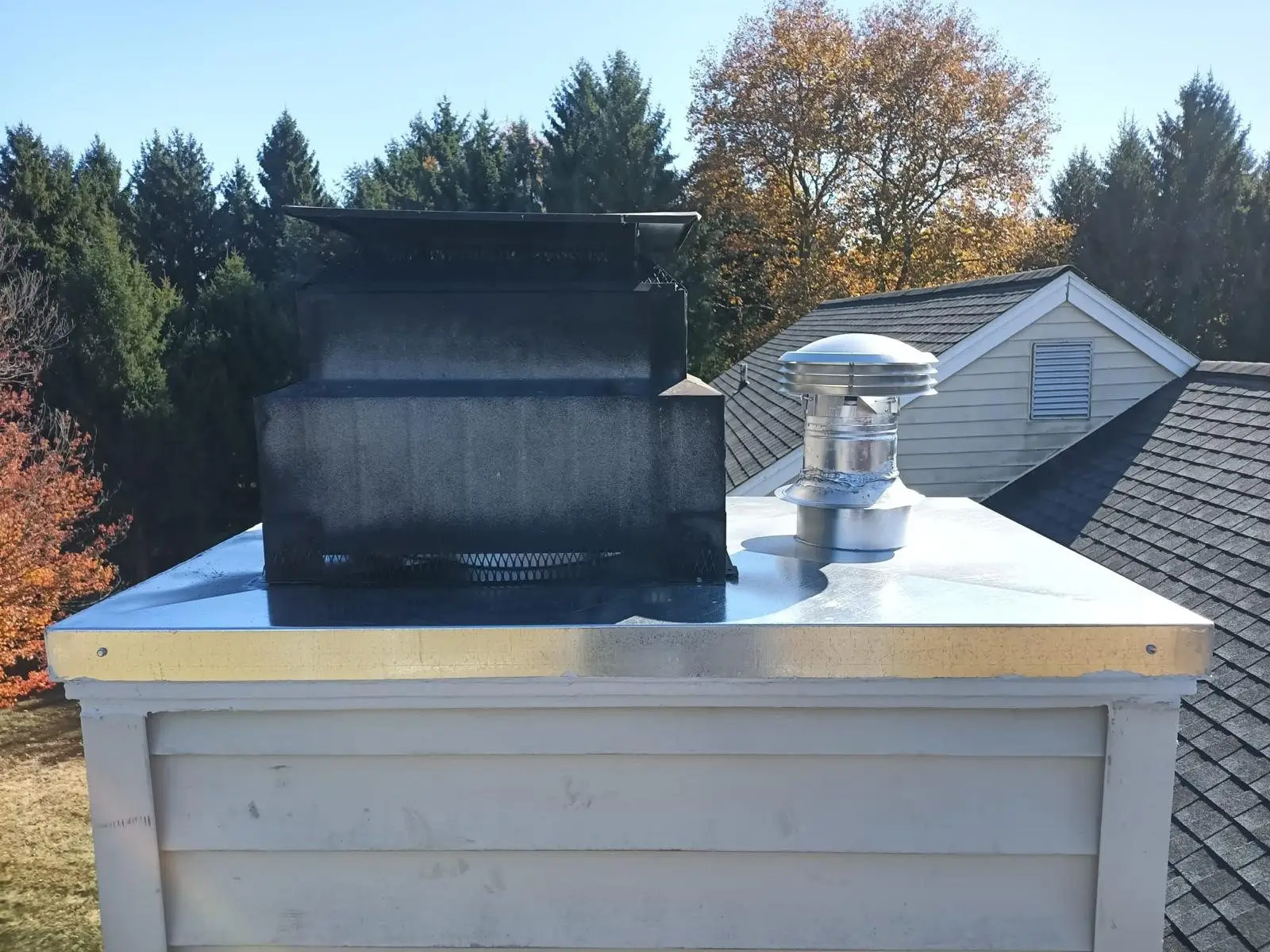 New metal chase cover and cap on a factory-built chimney