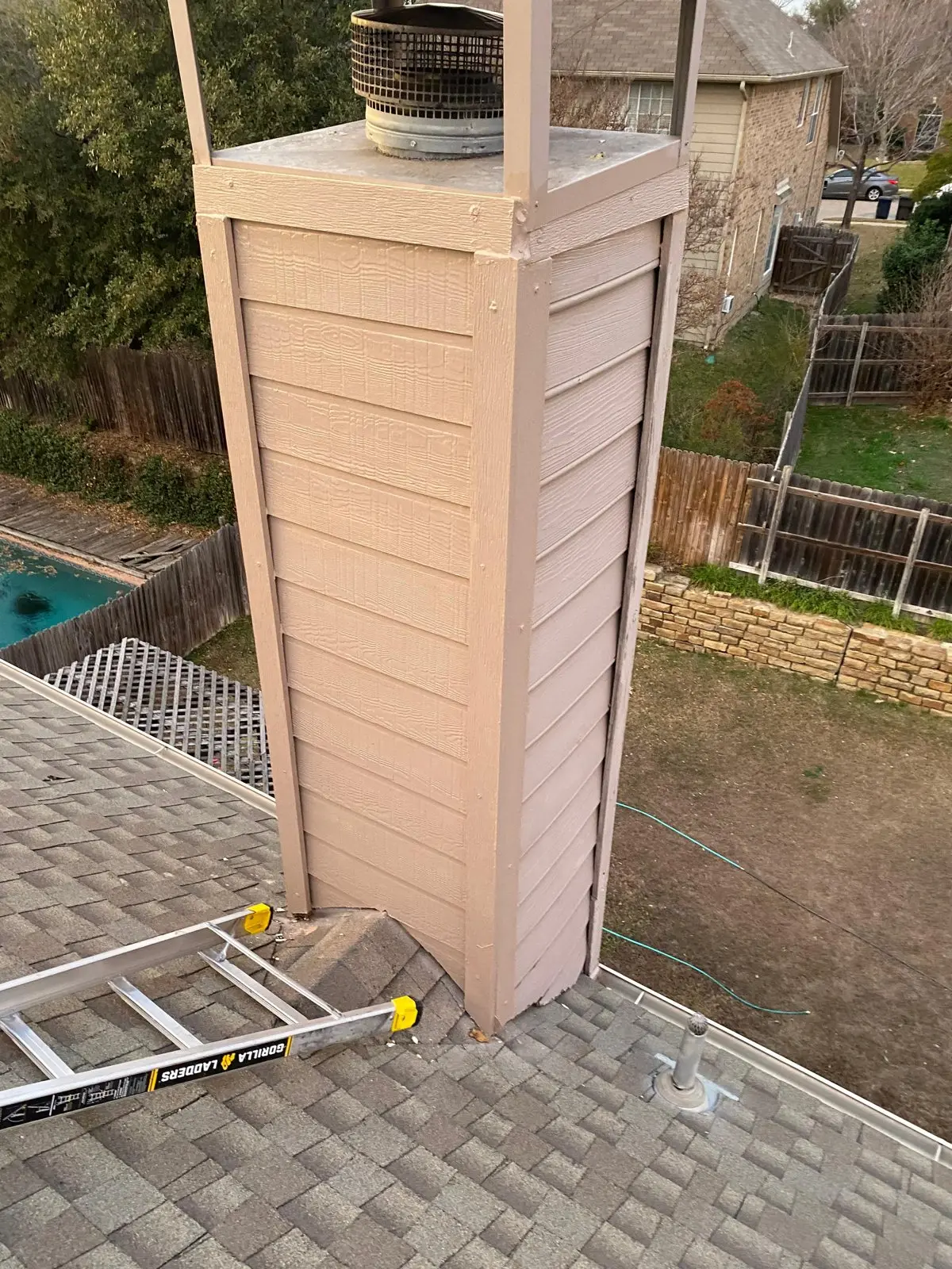 Chimney chase with new siding after repair