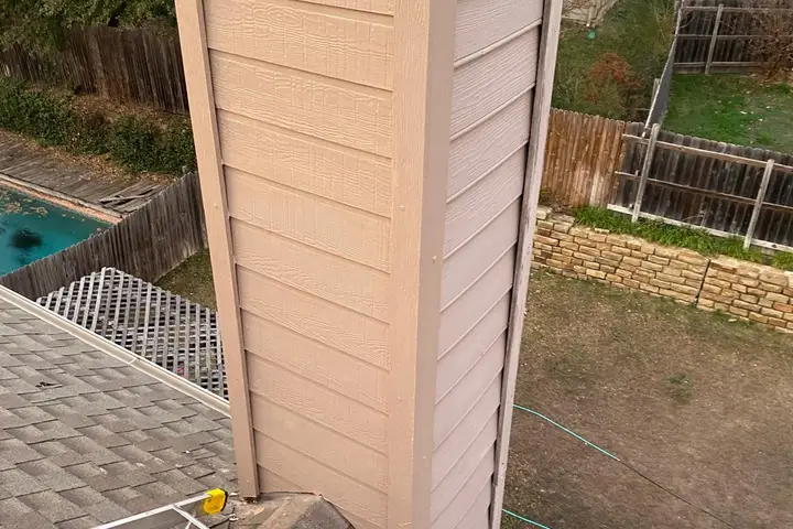Chimney chase with new siding after repair