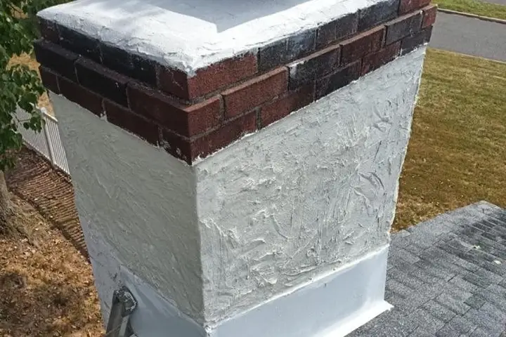 Brick chimney with a new crown and waterproofed brick
