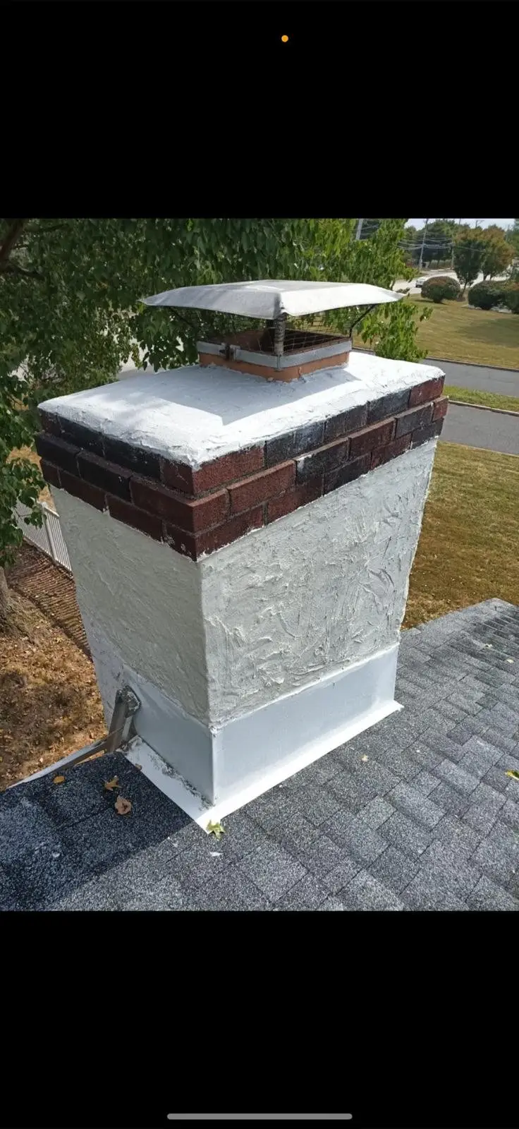 Brick chimney with a new crown and waterproofed brick