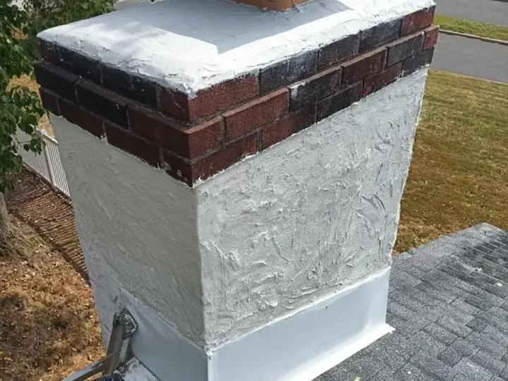 Brick chimney with a new crown and waterproofed brick