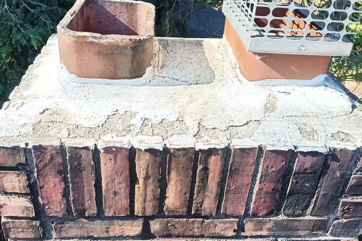 Rebuilt chimney crown on a brick chimney