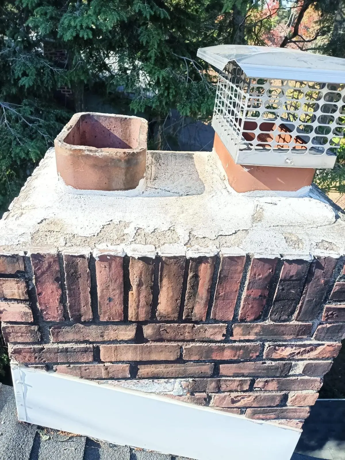 Rebuilt chimney crown on a brick chimney