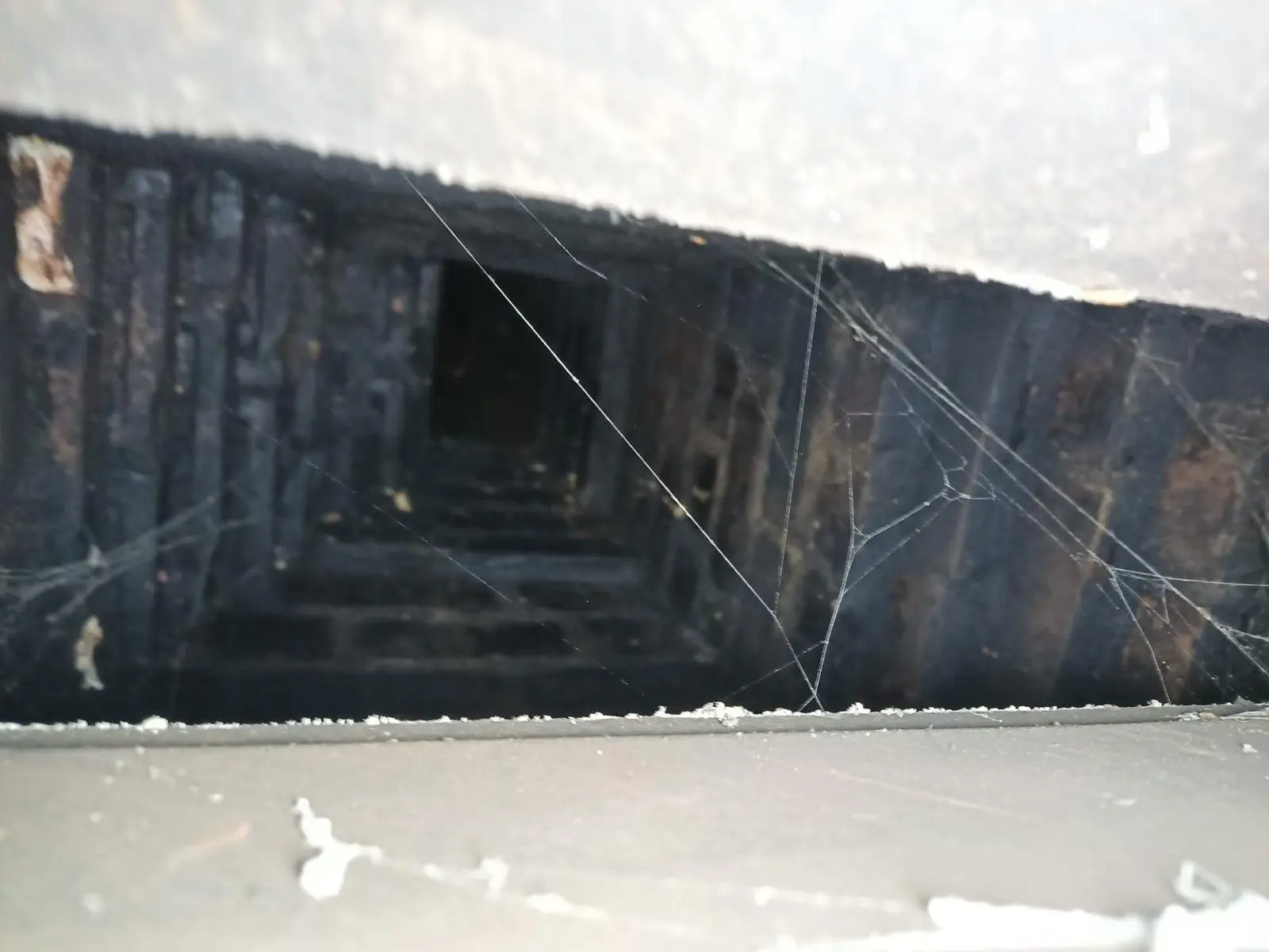 Throat damper inside a fireplace viewed from the firebox