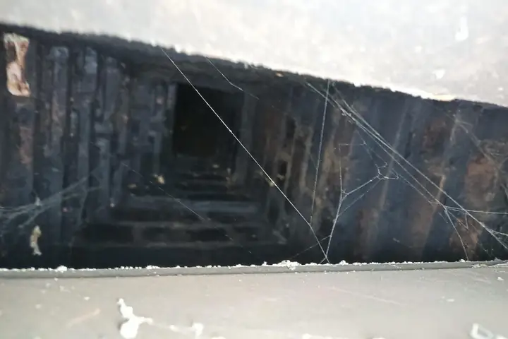 Throat damper inside a fireplace viewed from the firebox