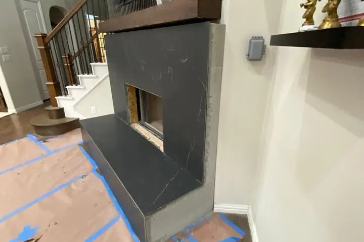 Remodeled fireplace with a modern dark surround