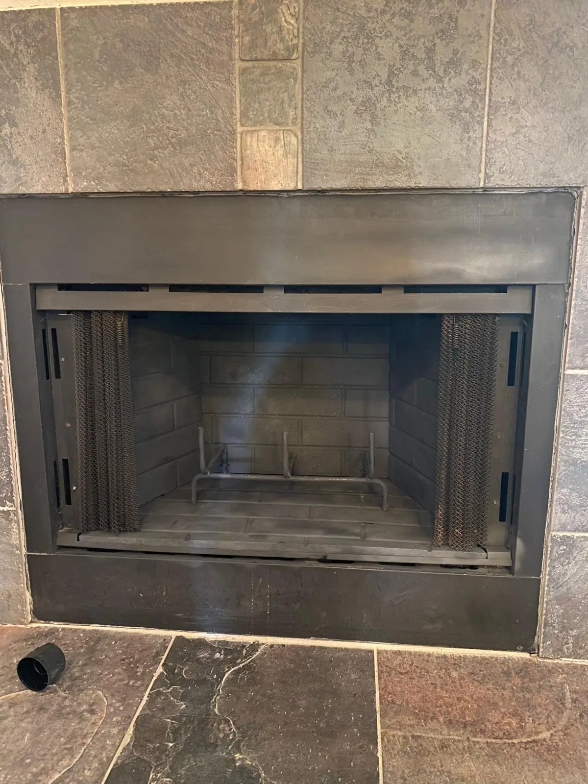 Clean prefab fireplace firebox during an inspection