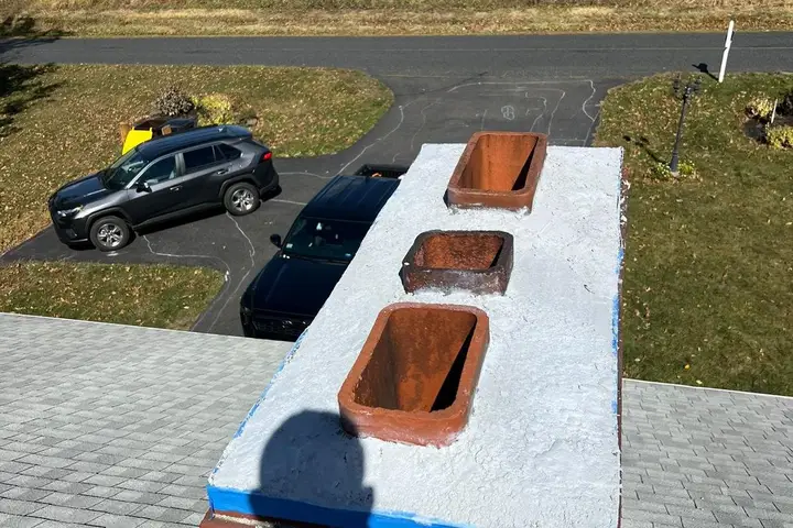 Three-flue chimney on a commercial rooftop